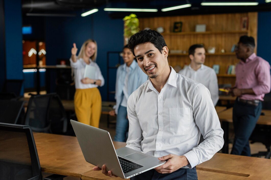 smiley-man-work-holding-laptop-posing_23-2148908835
