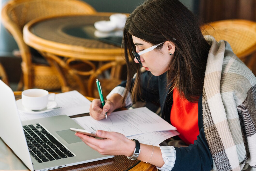 businesswoman-using-laptop-coffee-shop_23-2148002144