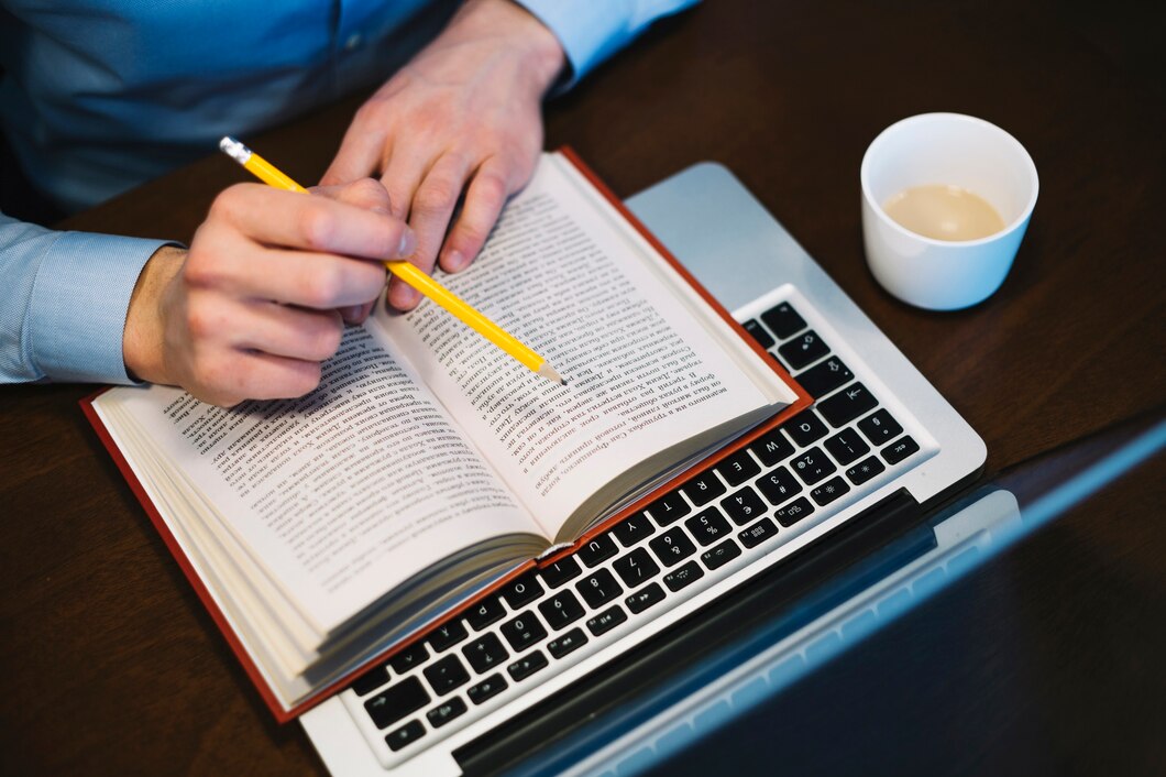crop-man-studying-near-laptop_23-2147779362
